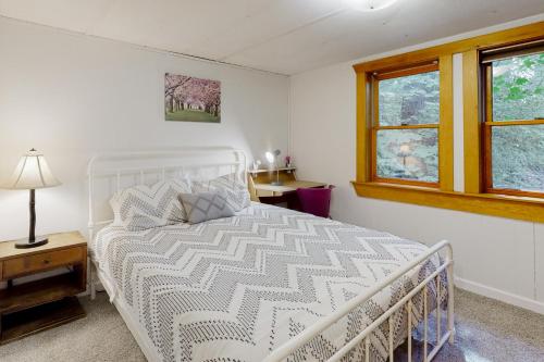 a bedroom with a white bed and a window at Ruby Creek Retreat in Port Orchard
