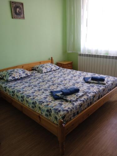 a bedroom with a bed with two objects on it at Къща за гости Ганчеви in Sozopol