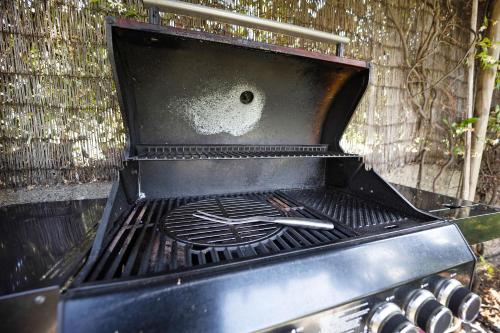 an outdoor grill with a dirty stove top oven at Ca dei Tati -Citr 1181 with Jacuzzi in Imperia