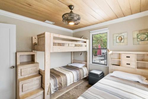 a bedroom with two bunk beds and a window at 113 Surf Song Resort in St Pete Beach