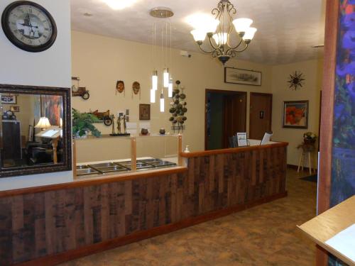 a lobby of a store with a clock on the wall at Knights Inn Woodstock in Woodstock