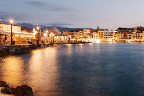 a view of a river in a city at night at Thyme Sea View Apartments by 8essentially in Souda