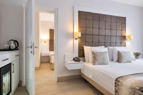 a hotel room with a bed and a mirror at Elite Hotel Yalıkavak in Yalıkavak