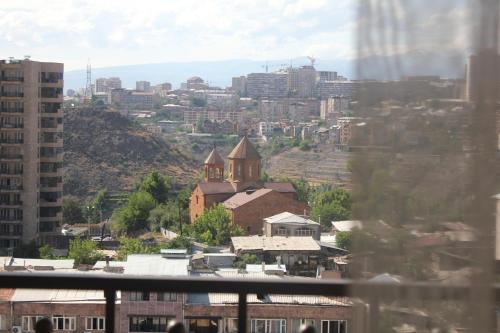 a view of a city with a church and buildings at Rooftop Apart-Hotel in Yerevan
