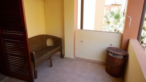 a small room with a chair and a window at Marina di Olbia Guest Apartment - self check-in - IUN R1646 in Olbia