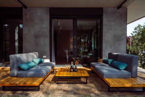 a living room with two couches and a table at Apartamenty Wydma & Las BlueApart in Jastarnia