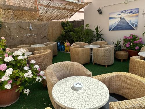 a restaurant with tables and chairs and flowers at Hotel Morolli in Rimini