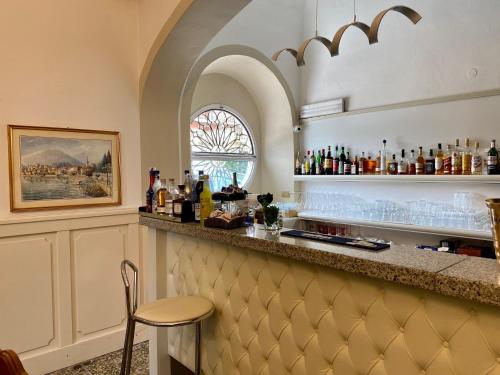 a bar in a room with a counter and a window at Hotel Due Palme in Mergozzo