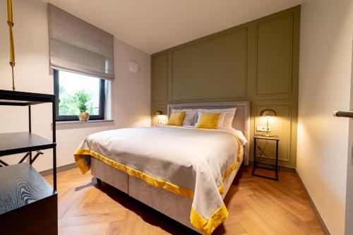 a bedroom with a large bed and a window at Hotel Gothards in Kuldīga