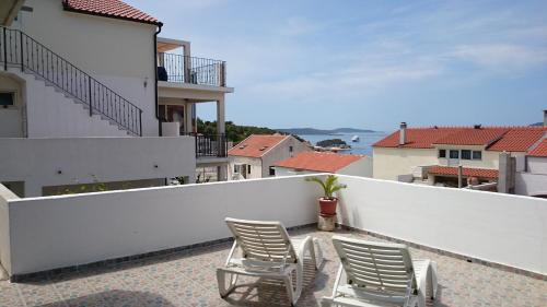 2 sillas en un balcón con vistas al océano en Villa Paladina, en Hvar
