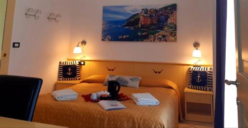 a hotel room with two beds with towels on them at Agriturismo I Pipetta in Levanto