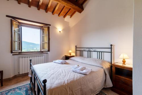 a bedroom with a bed with two towels on it at Pugnano Alto - Appartamento Tartufo in Lisciano Niccone