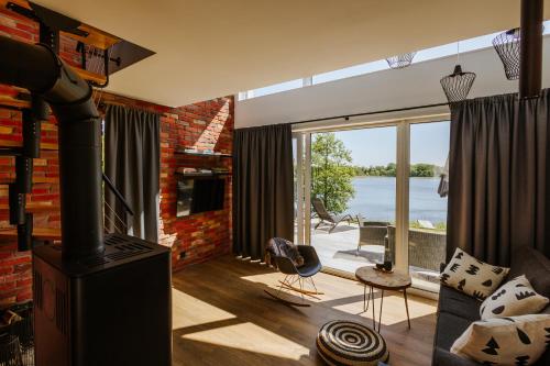 a living room with a fireplace and a brick wall at Warmiński Sad in Olsztyn