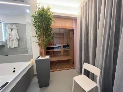 a bathroom with a potted plant and a sink at La Casba in Paola