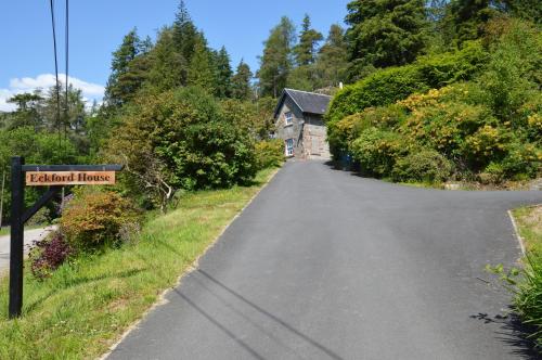 a road leading to a house with a street sign at Eckford House in Dunoon