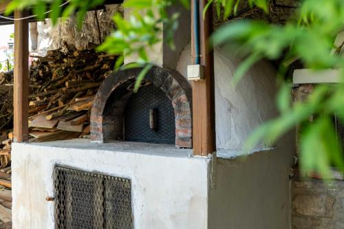 a brick oven sitting on the side of a building at House Rachati in Zaros