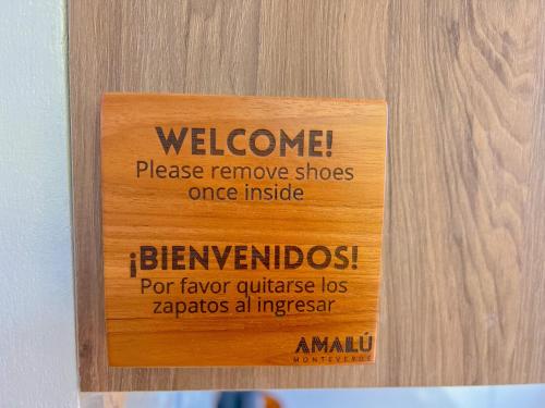a sign on a door with a welcome sign on it at Amalú Luxury View Cabins in Monteverde Costa Rica