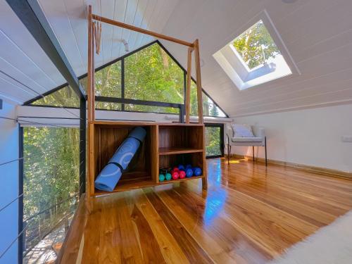 an attic room with a play area with a window at Amalú Luxury View Cabins in Monteverde Costa Rica