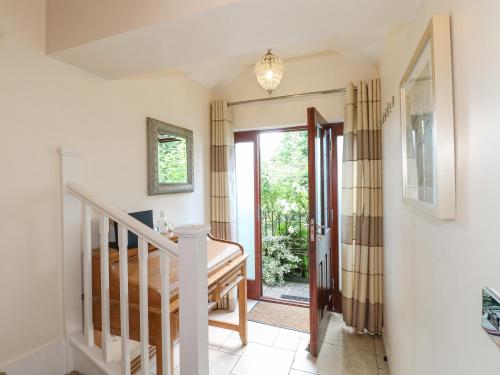a hallway with a staircase and a door to a yard at The Lillies in Great Rowsley
