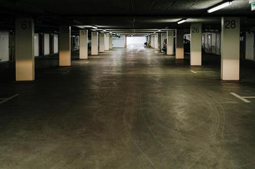 an empty parking lot with columns in an empty parking garage at Butique Apartman in Balatonlelle