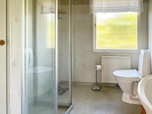 a bathroom with a shower and a toilet and a window at 6 person holiday home in SÖLVESBORG-By Traum in Sölvesborg