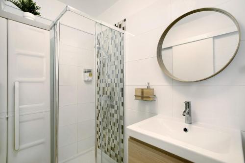 a bathroom with a shower and a sink and a mirror at Estudio Torres del Sol in Playa de las Americas