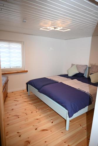 a bedroom with a bed in a room with a window at Ferienwohnung Rapunzel in Nideggen