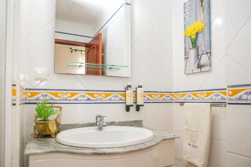 a bathroom with a sink and a mirror at Villa House Joana Vasconcelos, Ocean view & Pool - Pata da Gaivota in Lourinhã