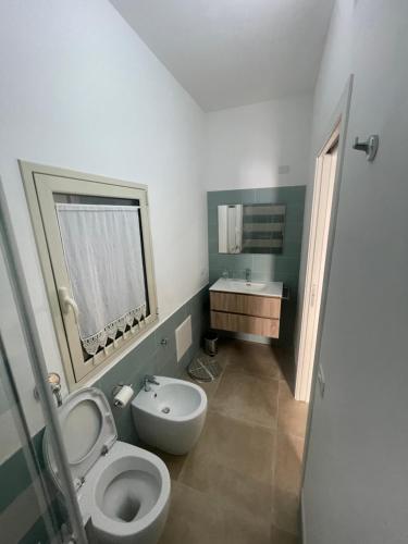 a bathroom with a toilet and a sink at Zohra in Castellammare del Golfo