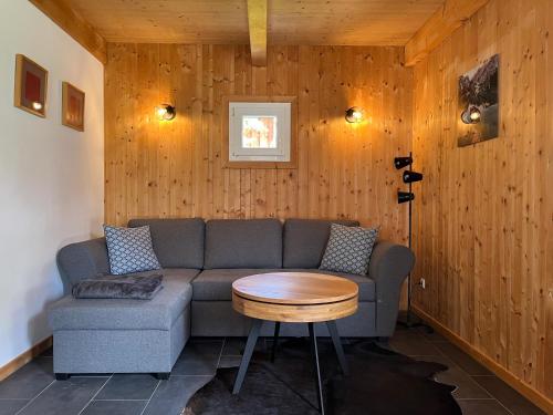 a living room with a couch and a table at Alpenferienhaus Sophia in Sankt Lorenzen ob Murau