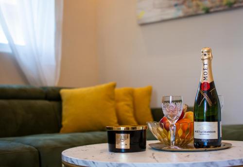 a bottle of wine and a glass on a table at Aqua Casa in Vrnjačka Banja