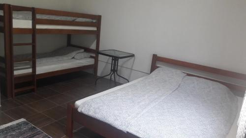 a bedroom with two bunk beds and a table at Lola Guest House in Vusanje