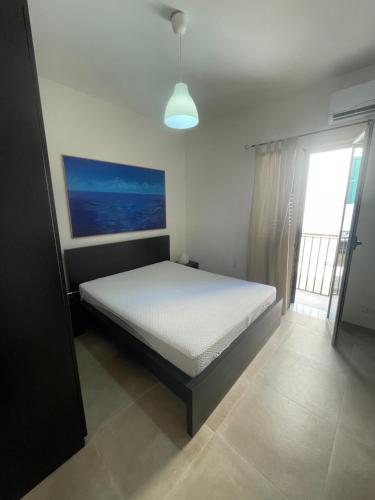 a bedroom with a bed in a room with a window at Zohra in Castellammare del Golfo