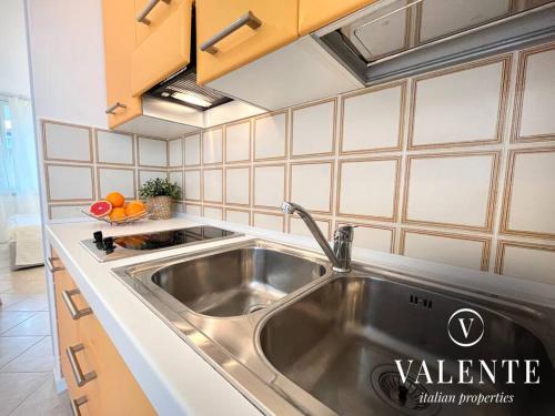 una cocina con fregadero de acero inoxidable en Casa al Mare - Torre del Lago- Valente Italian Properties, en Torre del Lago Puccini