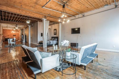 a living room with a table and chairs at Queen G Investments apts in Detroit