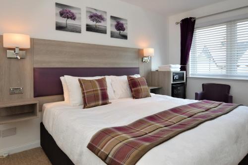 a bedroom with a large bed in a room at Fyne Rooms in Tighnabruaich