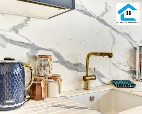 a kitchen sink with a gold faucet at Seaside Apartment By Bluehouse Short Lets Brighton With Stunning Views Leisure Family in Brighton & Hove
