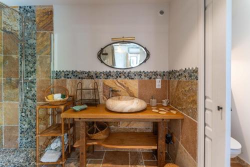 a bathroom with a sink and a shower at Villa La Mireio in Malaucène
