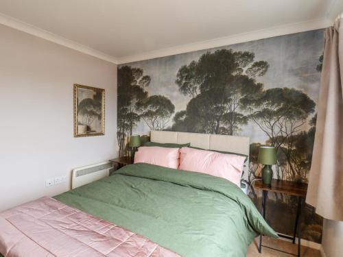 a bedroom with a bed and a painting on the wall at Handale Banks Farm Lodge in Saltburn-by-the-Sea