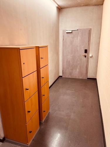 an empty room with wooden cabinets and a door at Zweirad Hotel Lenne in Schwerin