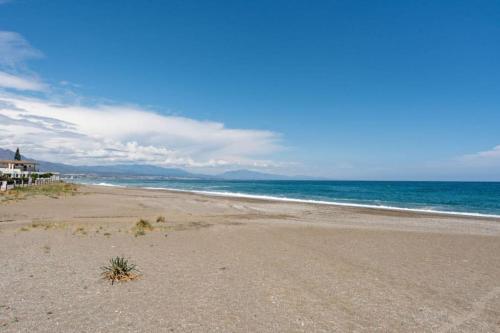 an empty beach with the ocean in the background at CT 240 - Beachfront Apartment -Don Juan Manilva in Manilva