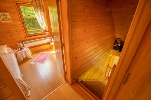 an inside view of a wooden cabin with a room at Chalet Le Pin à 2 pas de GERARDMER, dans la vallée des lacs in Xonrupt-Longemer