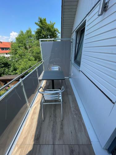 a table and a chair sitting on a balcony at Gästehaus Miri in Lindau