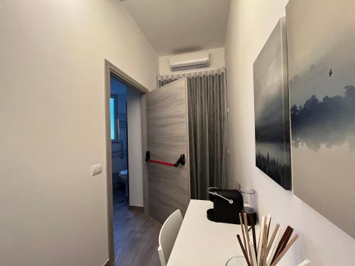 a room with a desk and a door to a bathroom at La Casba in Paola