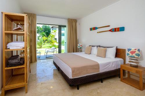 a bedroom with a large bed and a balcony at Amar'e Aparthotel & Spa in Las Terrenas