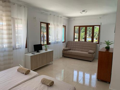 a living room with two beds and a couch at Casa los Pinos Calpe Playa in Calpe