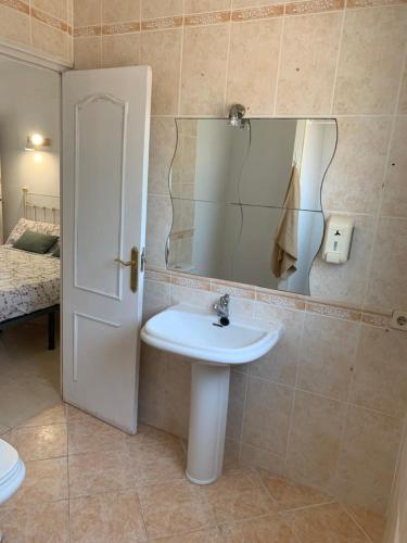 a bathroom with a sink and a mirror at Casa los Pinos Calpe Playa in Calpe