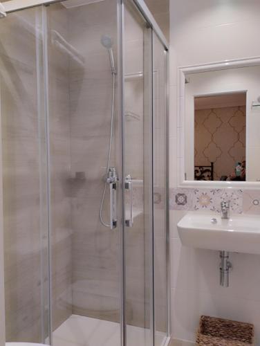 a bathroom with a shower and a sink at Hospedaje Vega in Santillana del Mar