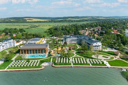 an aerial view of a resort next to the water at Mövenpick Balaland Resort Lake Balaton in Szántód