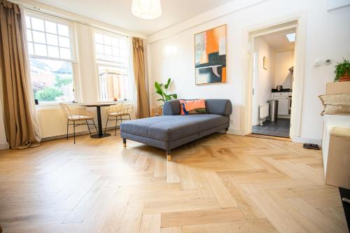 a living room with a couch and a table at Cute Beach House Zandvoort in Zandvoort